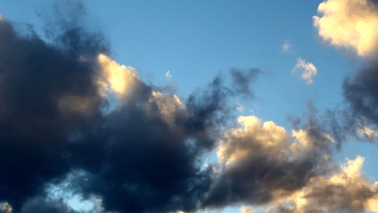 Dark clouds obscuring the sun and lighter clouds - Depression and Low Mood